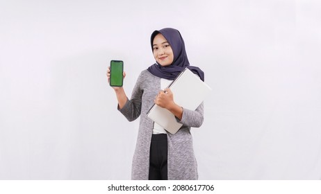 Asian Girl Carrying Laptop Showing Smartphone Screen Isolated On White Background