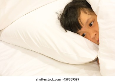 Asian Girl Child In Bed Suffering Insomnia Cannot Sleep; Sleeping Disorder Problem Difficulty At Night. Young Little Kid Anxiety Trying To Fall Asleep On White Bed Sheet And Pillow