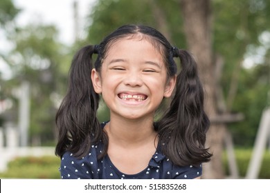 Asian Girl Child Showing Front Teeth With Big Smile