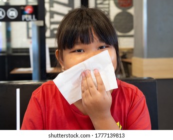 Asian Girl Is Cleaning Her Mouth. After Eating Delicious Food During The Semester Break