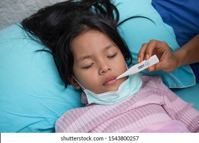 An Asian Girl Is Closing Her Eyes With A Woman's Hand Holding A Thermometer To The Mouth. May Have A Cough Until Sore Throat, Difficulty Swallowing, Colds, Flu Or Fever, Meet A Doctor At The Hospital