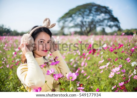  Asian girl in Cosmos flower garden.