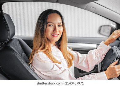 Asian Girl Is Driving A Car. Buying A New Car And Driving Pleasure. Beautiful Woman Driver.