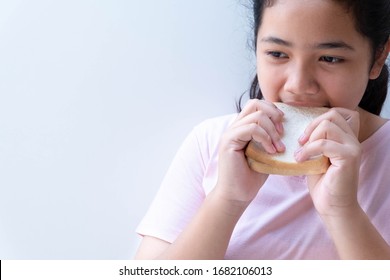 Asian Girl Eating Bread Isolated On White Background. Close Up.