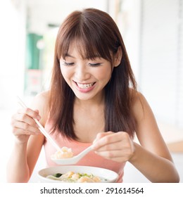 Asian Girl Eating Delicious Soup Dumplings At Chinese Restaurant. Young Woman Living Lifestyle.