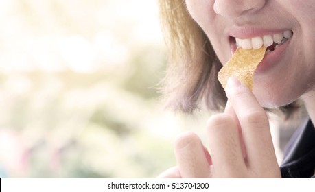 Asian Girl Eating Potato Chips.Vintage Style.