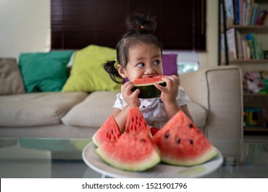 Asian Girl Eating Watermelon Indoor.