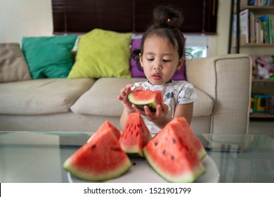 Asian Girl Eating Watermelon Indoor.