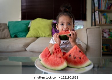 Asian Girl Eating Watermelon Indoor.