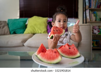 Asian Girl Eating Watermelon Indoor.