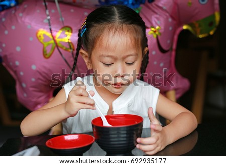 Asian girl enjoy eating miso soup at japanese restaurant