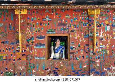 Asian Girl Enjoy Travel In Wat Xieng Thong Temple One Of The Most Famous Attraction Place In Luang Prabang, Laos.