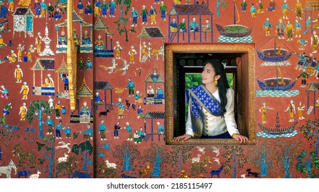 Asian Girl Enjoy Travel In Wat Xieng Thong Temple One Of The Most Famous Attraction Place In Luang Prabang, Laos.