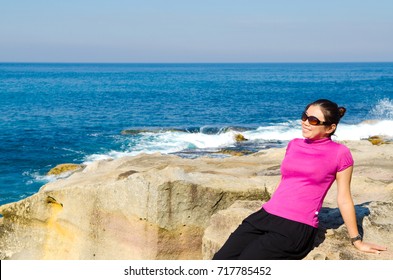 Asian Girl Explores The Coastline Of Bondi Beach In Sydney,Australia.