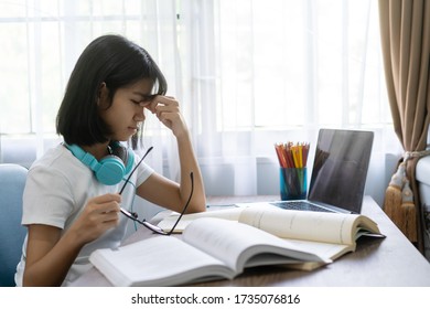 Asian Girl Eye Strain Tension Or Blurry Vision Problem, Studying Homework Online Lesson At Home, Social Distance Online Education Idea Concept