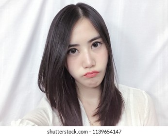 Asian Girl Feel Moody With White Background.