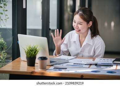 Asian Girl Happy And Charming Wear Headphones To Communicate By Video Conferencing At Your Desk. Using A Laptop Computer, Video Chat