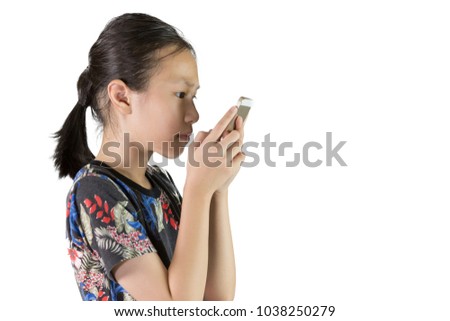 Asian girl have eye problems,Nearsighted concept,Visually impaired,Girl is using a mobile smart phone isolated on white background