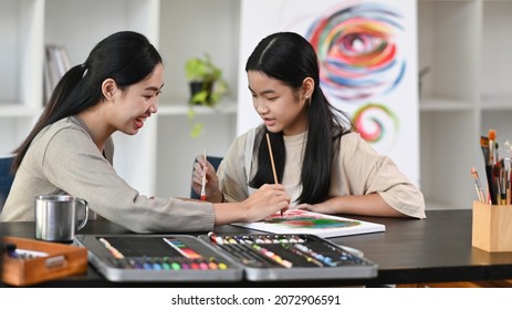 Asian Girl Having Fun Painting With Teacher In Art Class. 