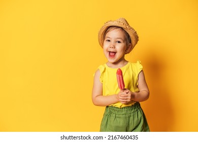 Asian Girl Holding Ice Cream On Stick In Front Of Yellow Background.