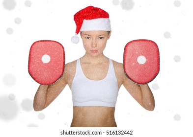 Asian girl holding implements for martial arts in snow isolated on white - Powered by Shutterstock