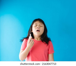 Asian Girl Holding Nasal Spray For Clean Virus.prevention Care With Saline Sea Salt Water.wash Nose With Spray Nasal.Sneeze Cough Cold On Nose.medical Health.relief Sinus Treatment.kid Child Spray.