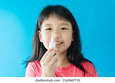 Asian Girl Holding Nasal Spray For Clean Virus.prevention Care With Saline Sea Salt Water.wash Nose With Spray Nasal.Sneeze Cough Cold On Nose.medical Health.relief Sinus Treatment.kid Child Spray.