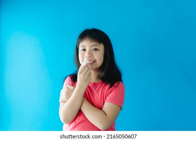 Asian Girl Holding Nasal Spray For Clean Virus.prevention Care With Saline Sea Salt Water.wash Nose With Spray Nasal.Sneeze Cough Cold On Nose.medical Health.relief Sinus Treatment.kid Child Spray.