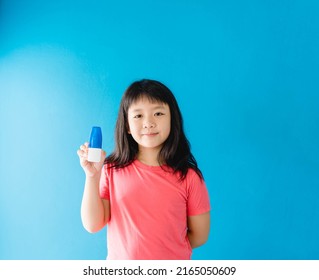 Asian Girl Holding Nasal Spray For Clean Virus.prevention Care With Saline Sea Salt Water.wash Nose With Spray Nasal.Sneeze Cough Cold On Nose.medical Health.relief Sinus Treatment.kid Child Spray.