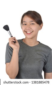 Asian girl holds a makeup brush isolated on white background