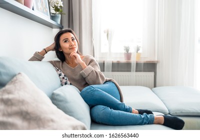 Asian girl at home deep in thoughts thinking and planning - Shutterstock ID 1626563440