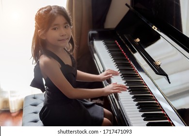 asian girl kids playing piano have talent and practice for up skill of music ability for future occupation.