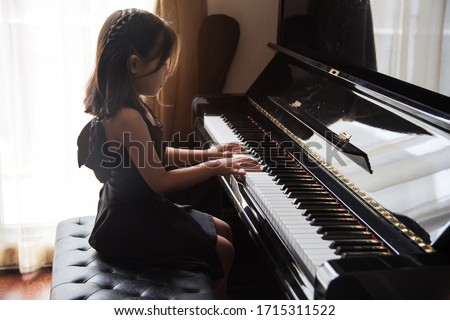 asian girl kids practice play piano for up skill of music ability for future occupation.