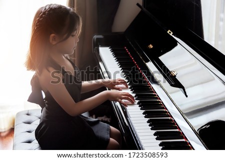 asian girl kids practice play piano for up skill of music ability for future occupation.