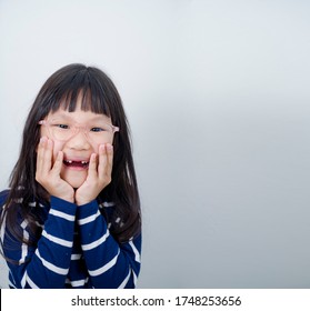 Asian Girl Laughing And Being Goofy Showing His Lost Teeth.