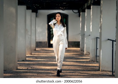 Asian girl with long black hair outdoor, asian woman in white clothes, lifstyle photo of woman in whine shirt and trousers outside, beautiful chinese woman in white outfit - Powered by Shutterstock