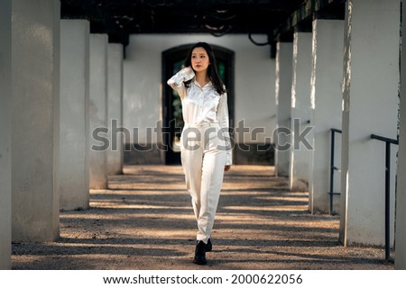 Asian girl with long black hair outdoor, asian woman in white clothes, lifstyle photo of woman in whine shirt and trousers outside, beautiful chinese woman in white outfit
