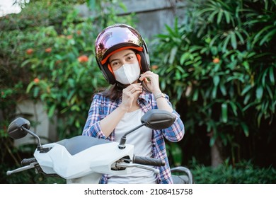 Asian Girl With Mask Tying Up Helmet Safety Strap