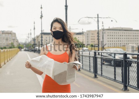 Asian girl with the mask in walking in the city