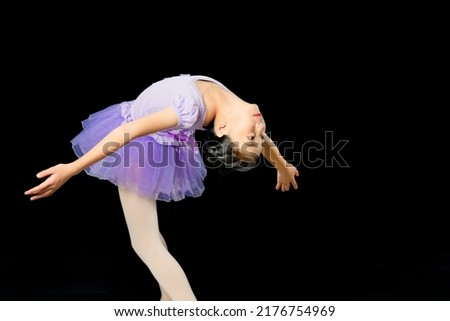 Asian girl performing figure skate. Figure skater. Layback ina bauer.