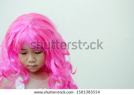 Asian girl in a pink wig,cosplay theme with a copy space