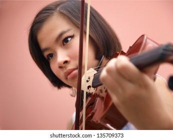 An Asian Girl Playing Violin