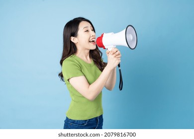 Asian Girl Portrait Holding Speaker, Isolated On Blue Background