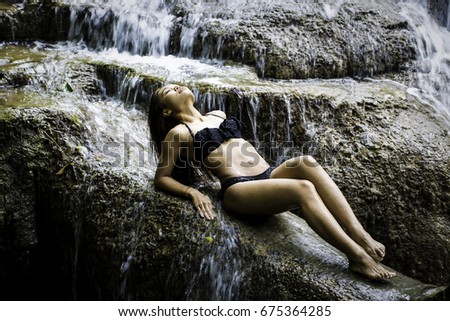 Similar – beautiful brunette short hair girl leaning on gray rock wall outdoors smiling happy