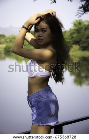 Similar – Brunette surfer woman with top and bikini holding surfboard