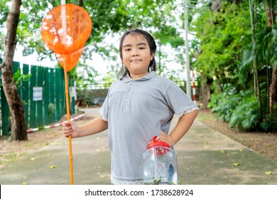 An Asian Girl Protrait, She Is Adventuring In A Wide World. Along With A Bug Catcher