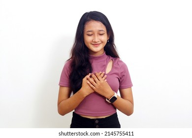 Asian Girl With Relieved Expression Smiling Closing Her Eyes. Isolated On White Background