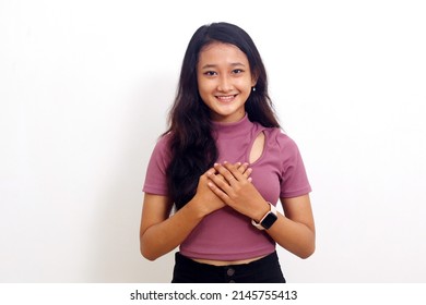 Asian Girl With Relieved Expression Smiling Looking At Camera. Isolated On White Background