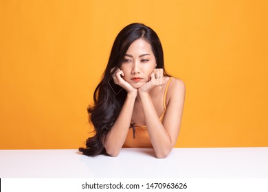 Asian Girl With Sad Emotion On Yellow Background