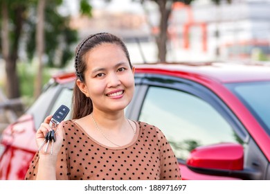 Asian Girl Showing The Car Key. 